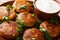 Tasty Aloo TikkiÂ is a popular Indian street food which is basically crispy and spicy potato patty with yogurt close-up on the